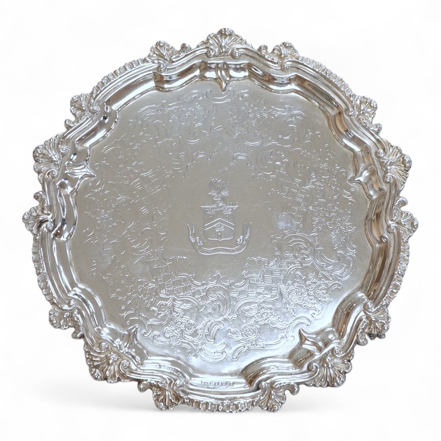A George V silver waiter, with engraved crest and shell and scroll border, Deykin & Harrison, Birmingham, 1910, 21.5cm, 8.9oz.